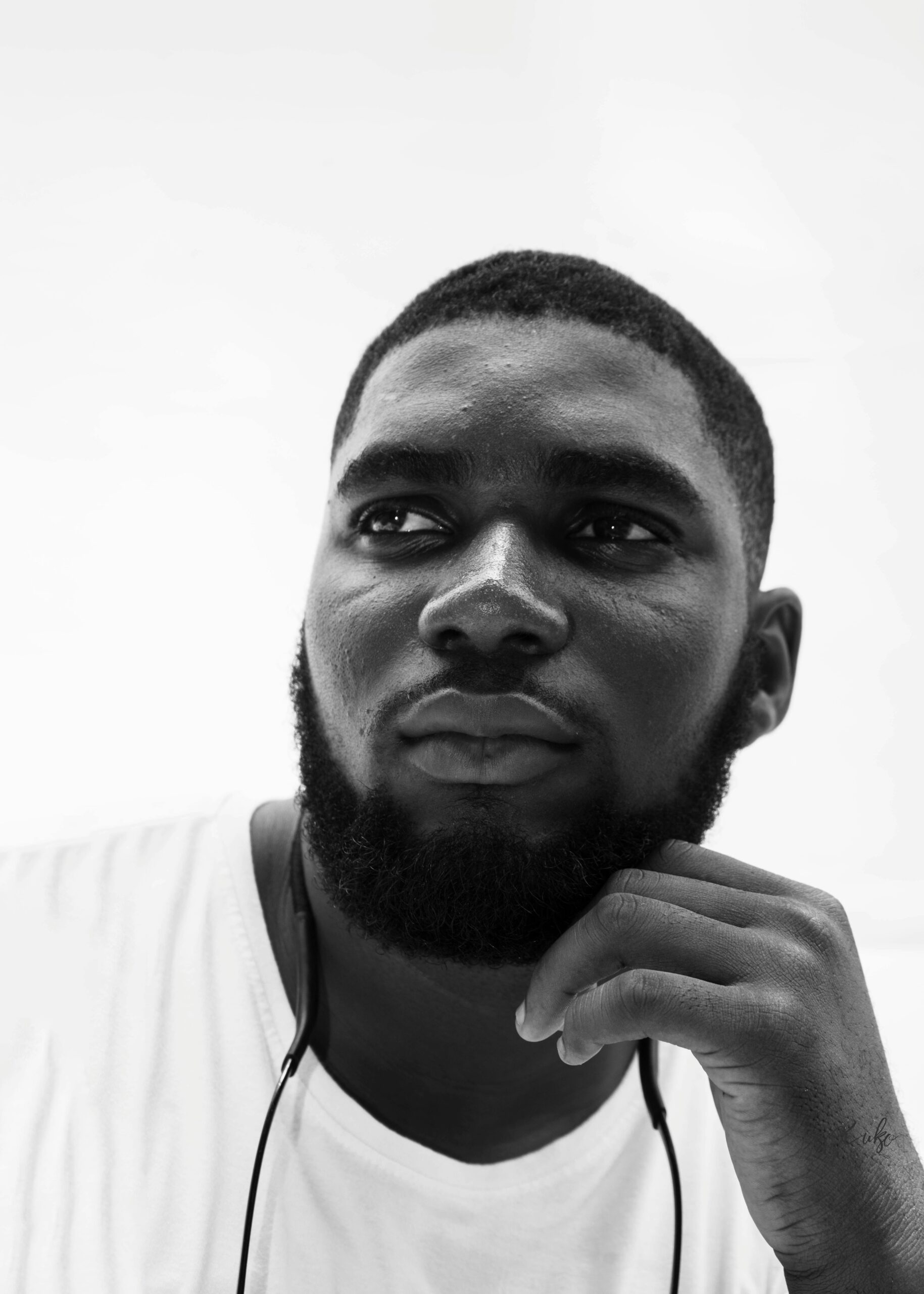 Monochrome portrait of a thoughtful African man with facial hair in Abuja, Nigeria.
